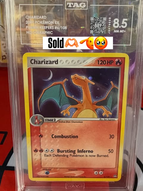 Power Keepers Charizard in a TAG 8.5 slab with a sold announcement